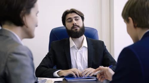 A Business Meeting Involves Discussion and Collaboration Among Colleagues in an Office Setting