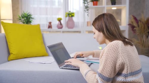 Young college student girl learning and learning remotely online using laptop.