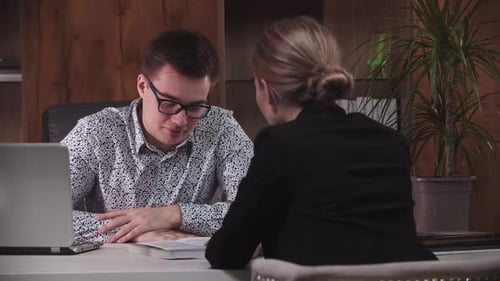 Work Interview Man and a Woman are Sitting at a Desk