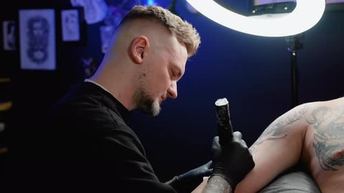 Tattoo Artist Working on Client's Arm