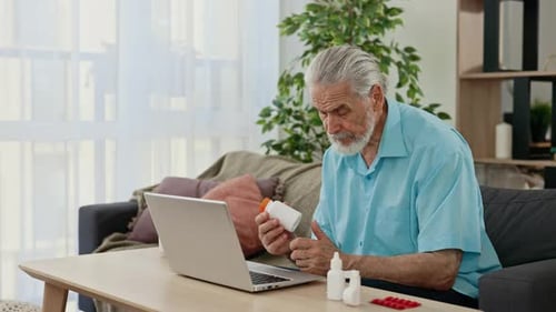 Senior Man Using Laptop Consults About Medicine