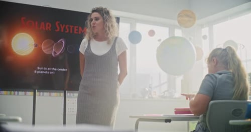 Astronomy Class Female Teacher Explaining Solar System to Primary School Children Using Digital