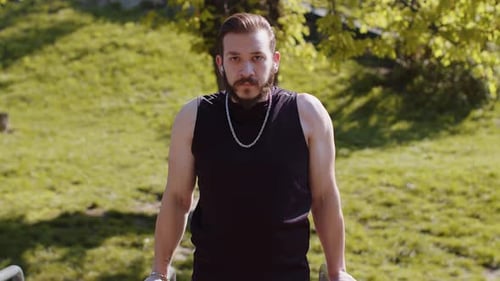 Athletic Lebanese Man in Sportswear Practicing Dips on Parallel Bars Training Triceps on Playground