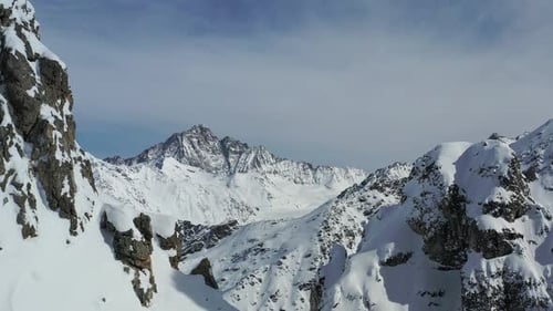 Stunning mountains with rocky snow covered hills, aerial footage in 4k