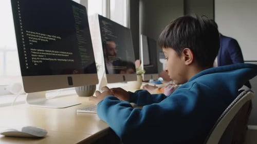 Kids Writing Programming Code on Desktop Computers and Teacher Checking