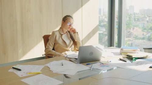 A Successful Blonde Businesswoman is Focused in a Sunlit Office Exuding Confidence in Her Modern