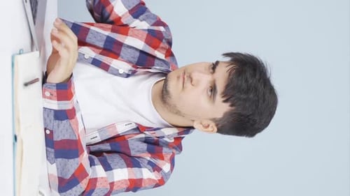 Young Man Working At Desk in Home Setting