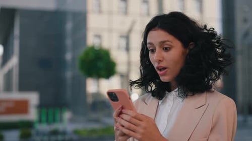 Woman Reacts to Good News on Mobile Phone