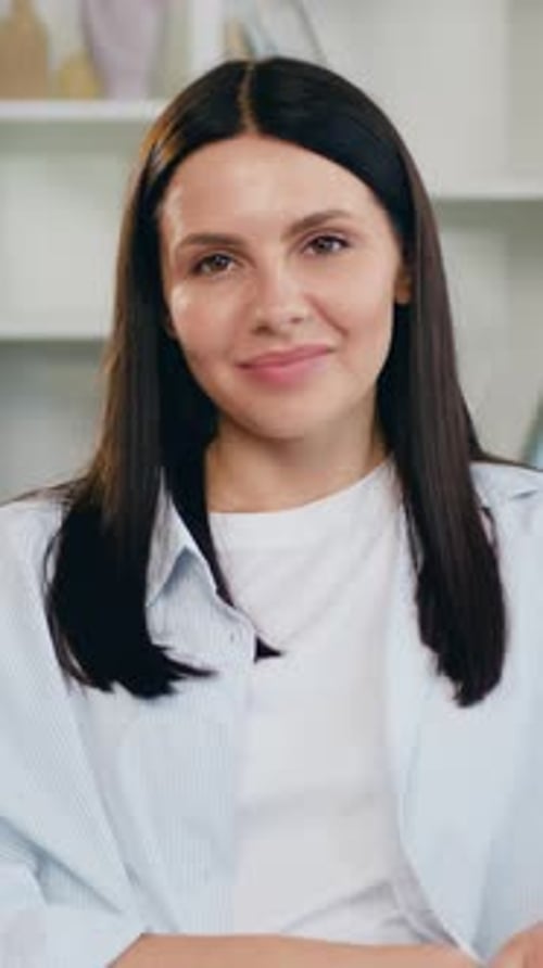 Attractive Woman Smiling at Camera in Bright Home