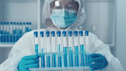 Scientist Holds Rack of Test Tubes in Lab