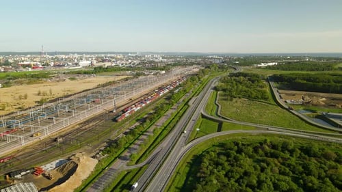 Large Train Depot With Many Cargo Trains in Terminal, Gdansk cityscape on background, Poland, sunny
