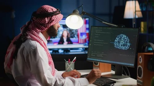 Man Works on Computer at Night