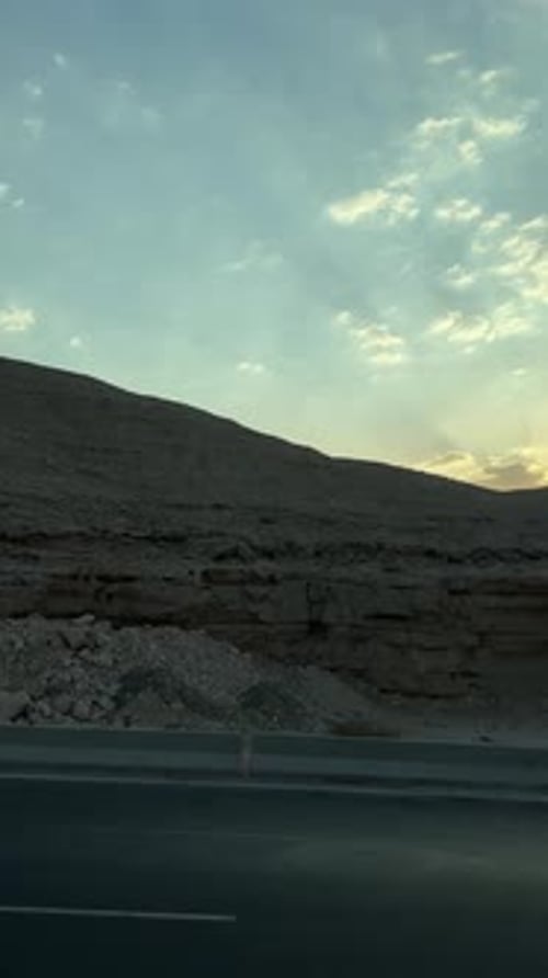 A view of a Mountain in desert from a car on high way, trucking shot