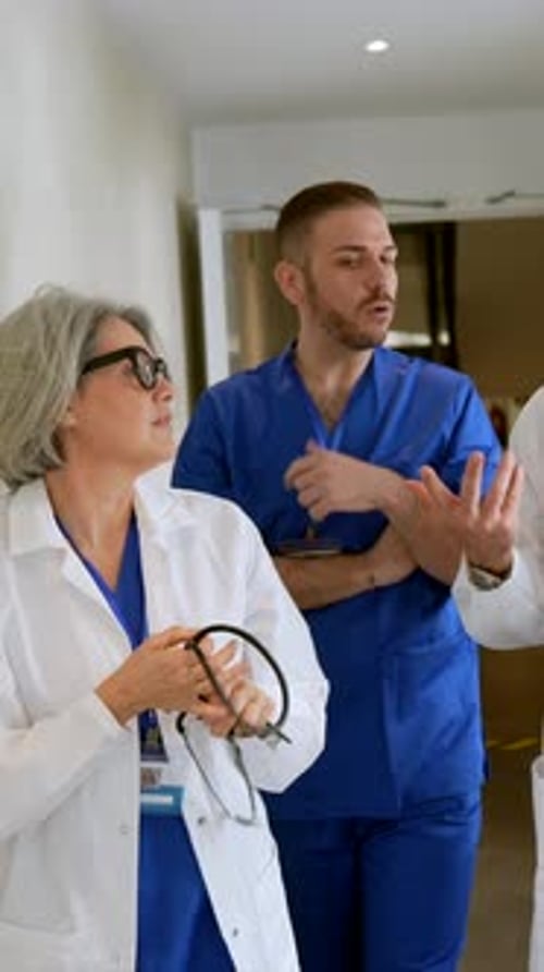Medical team discussing patient case in hospital corridor