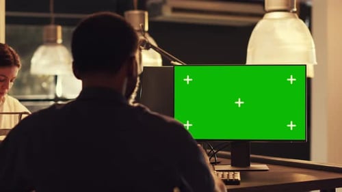 Adults Using Computer with Chroma Key in Office