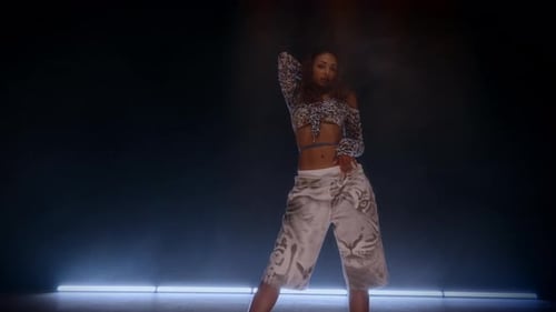 Dynamic Hip Hop Movements By Woman In A Studio Filled With Beam Lights