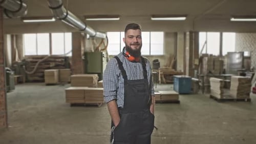A Mature Carpenter Standing Confidently in His Workshop RAW Video Record