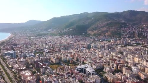 Aerial view over sandy beach and coast of the southern city on a sunny day