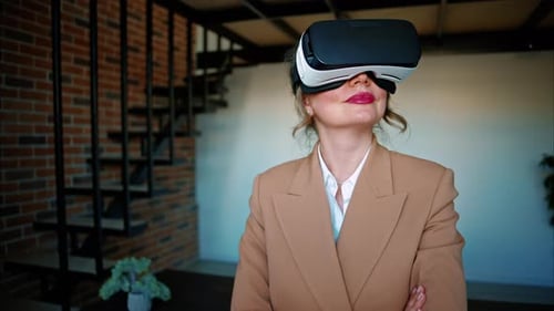 Woman smiling while using a Virtual Reality headset in an office
