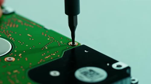 Screwdriver Tightening Screw on Computer Hard Drive