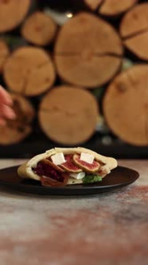 pitas with different fillings on a black plate in a restaurant