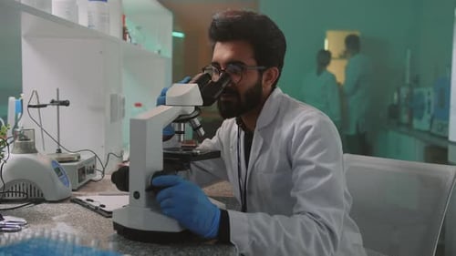 Scientist Using Microscope in Bright Lab Setting