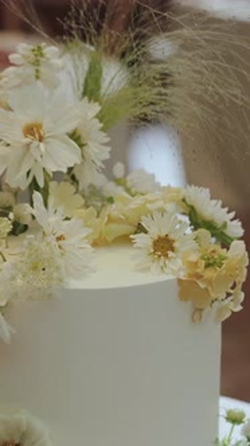 Wedding Cake Decorated with White and Yellow Flowers