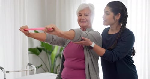 Senior Woman Exercising With an Adult's Assistance