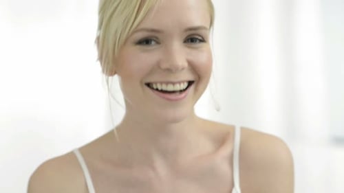 Woman Smiling in White Room