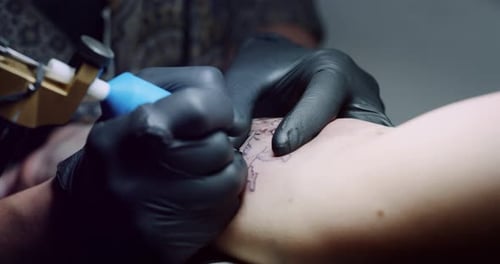 Milan/Italy-01.02.2019:Slow motion of professional master of the art of tattooing doing a tattoo t