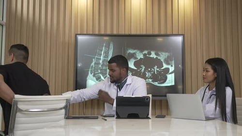 Doctor Examining Patient in Medical Conference Room