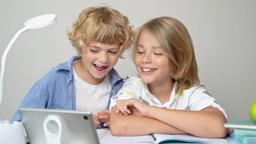Middle Primary School Students Boy Girl Remotely Studying Writing Book Homework and Tablet at Class