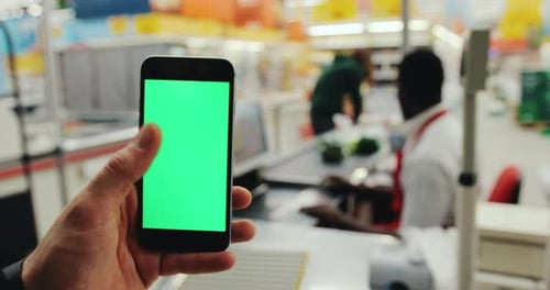 Close Up Man Hands Hold Touch Phone Green Screen Supermarket Background Seller Serves Client