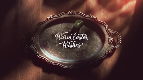 Green Easter egg spinning on a vintage silver tray.