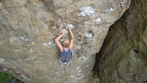 Young Woman Climbing Steep Wall of Rocky Mountain Girl Climber Overcomes Challenging Route Engaging