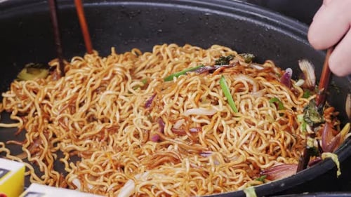 Noodles and Vegetables Cooking in a Pan