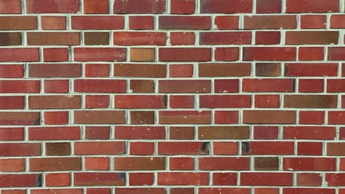 reddish brick wall, moving from left to right, truck shot
