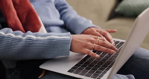Hands, woman and typing with laptop on sofa for proofreading draft, remote work and blog editing