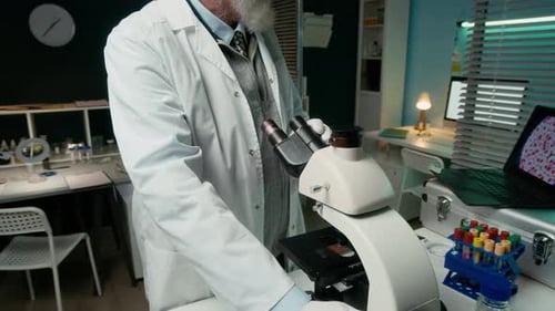 Scientist Using Microscope in a Bright Laboratory