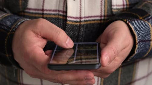 Male Hands with Mobile Phone Close Up Man Finger Touching Scroll Page App