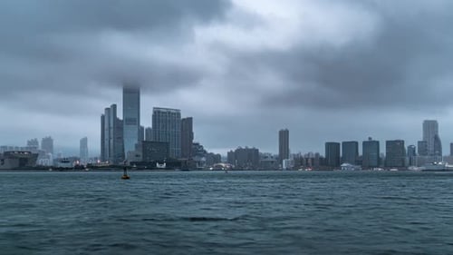 Time lapse of rainy early morning over Victoria Harbour and Tsim Sha Tsui Hong Kong