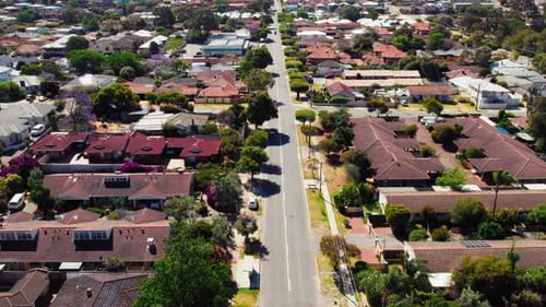 Suburban street with houses on either side of the road in typical australian neighborhood