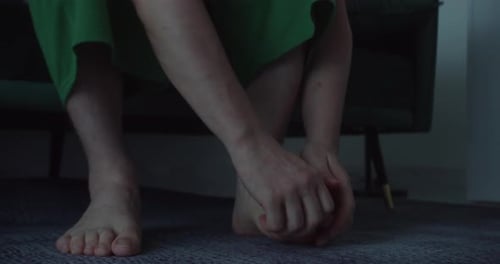Adult Massaging Foot Indoors, Close Up