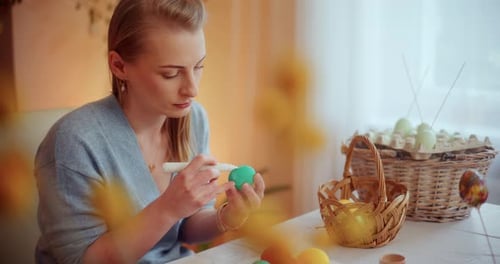 Portrait of Woman Painting Easter Eggs for Easter Holidays