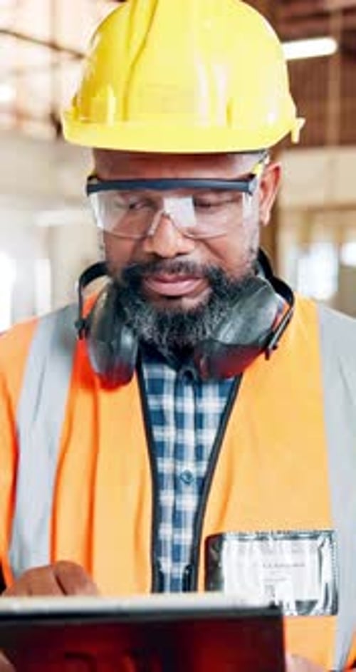 Black man, carpenter and research with tablet for inventory, checklist or maintenance in workshop