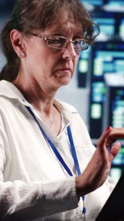 Woman Working with a Tablet in Control Room
