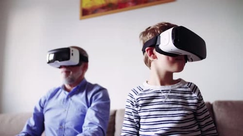Boy and Senior Man Using Virtual Reality Headsets