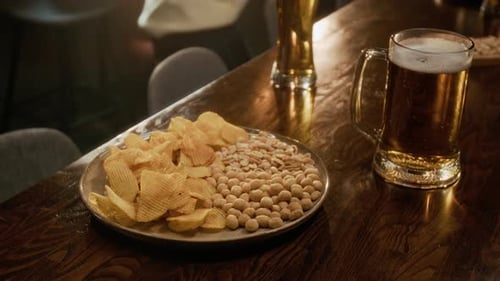 Potato Chips and Peanuts with Beer Mug Served for Pub Snacking