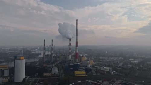 Air Pollution Concept Aerial Drone Video of a Factory Chimney in a City's Industrial Zone with Smoke