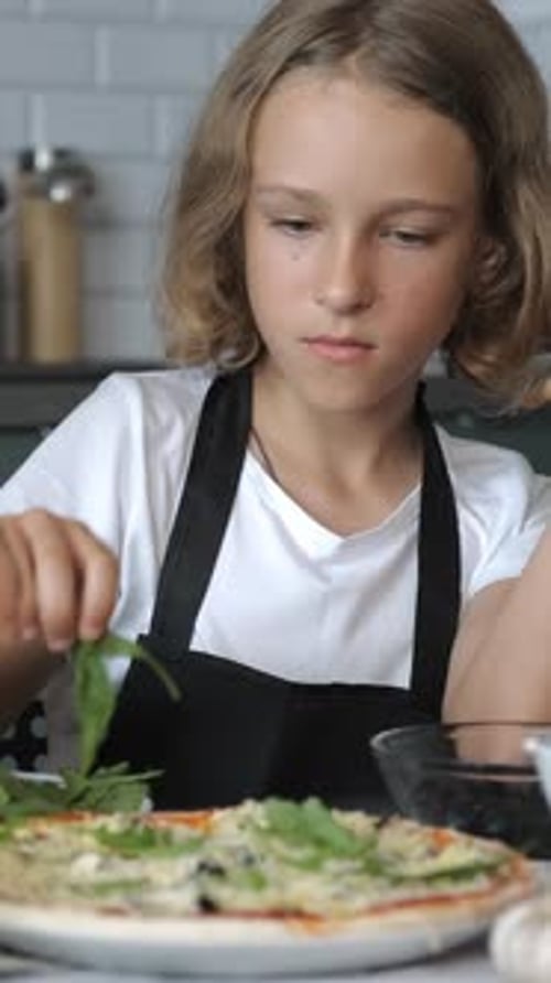 Child Preparing Pizza in Kitchen